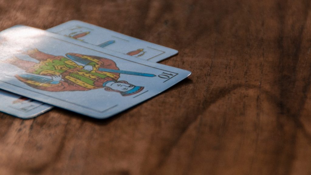 A close-up view of decorative playing cards on a wooden surface.