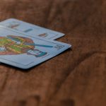 A close-up view of decorative playing cards on a wooden surface.