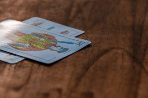 A close-up view of decorative playing cards on a wooden surface.