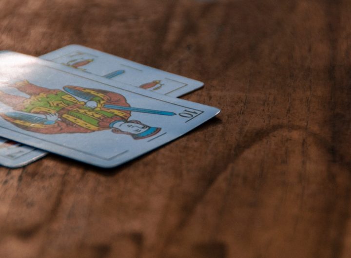 A close-up view of decorative playing cards on a wooden surface.